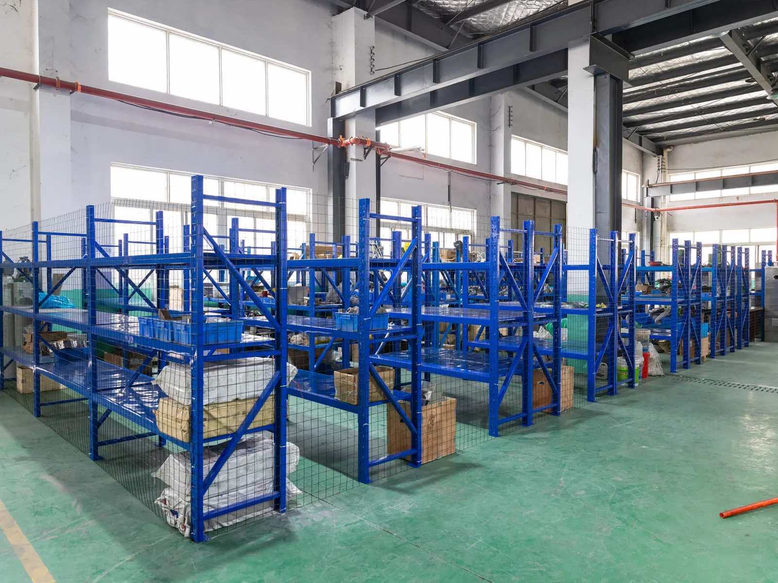 Blue storage racks inside the Planet Machinery warehouse