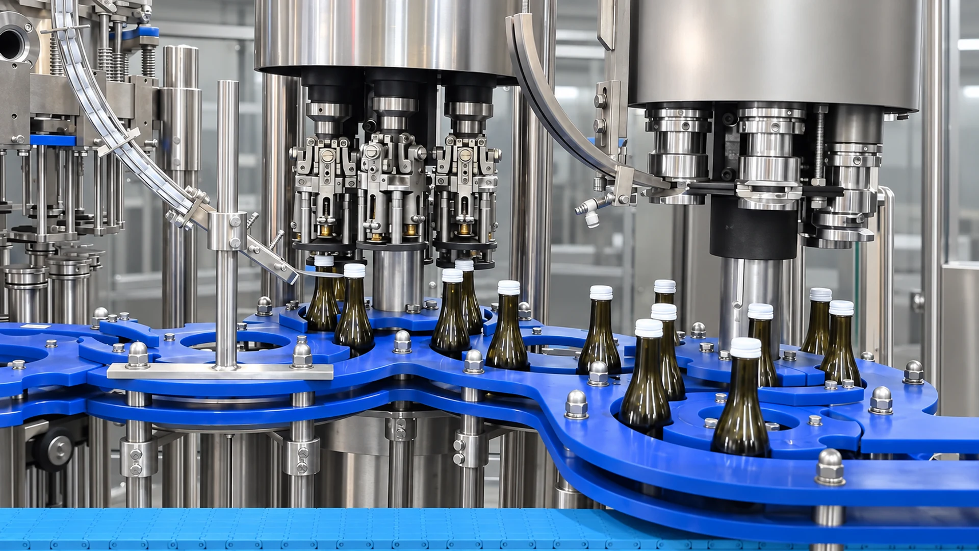 Glass bottles entering the PLANET carbonated soft drink filling monoblock before filling
