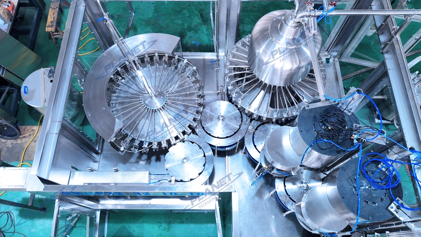 Overhead view of the PLANET hot-fill monoblock showing rotary stations and transfer starwheels