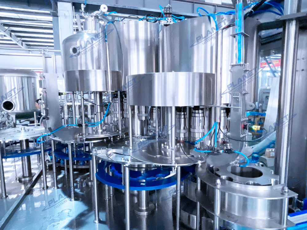 Enclosed stainless-steel rotary beverage filling and capping equipment shown as a representative machine view