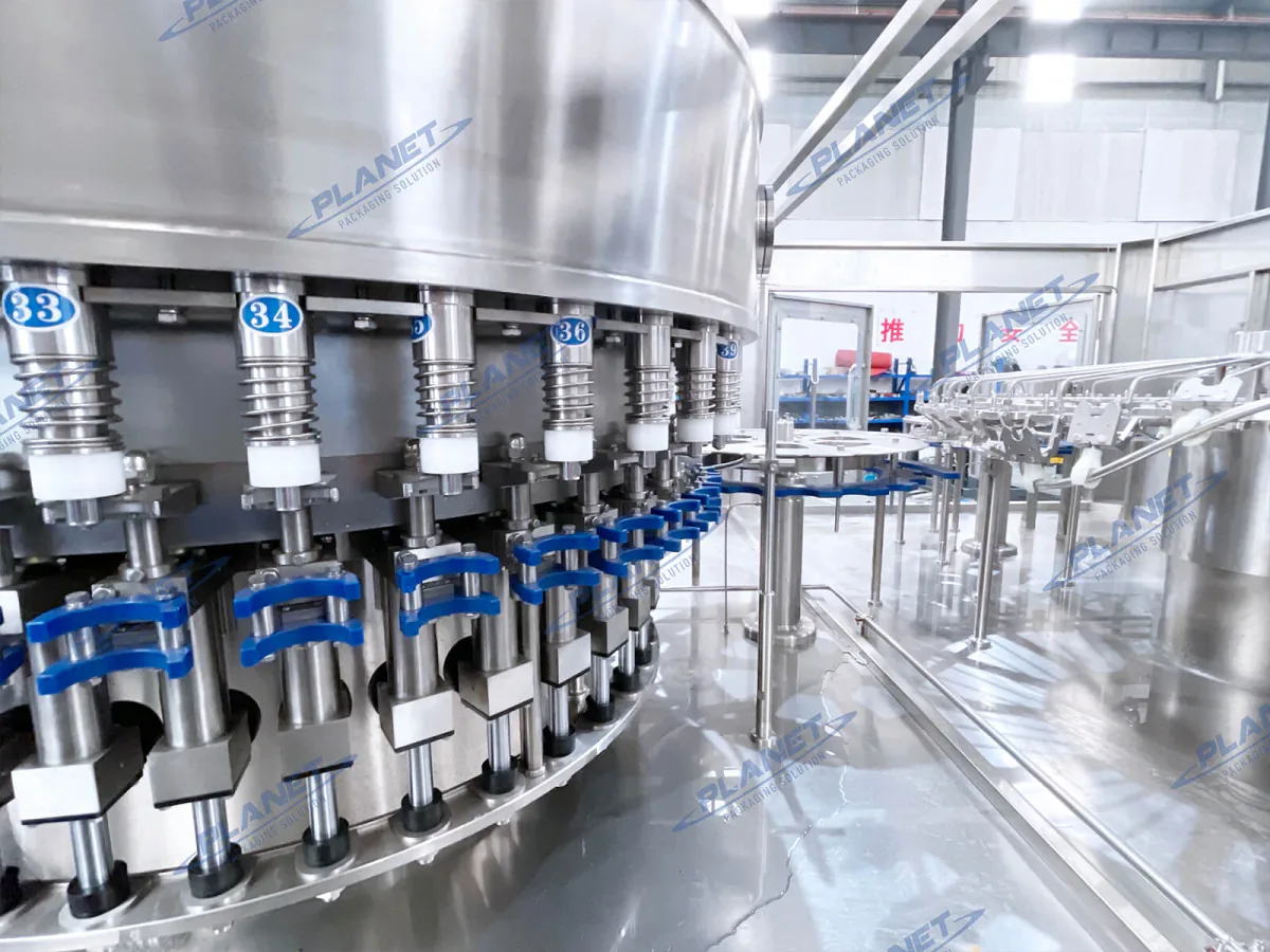 Close-up of stainless-steel bottled-water filling valves prepared for maintenance